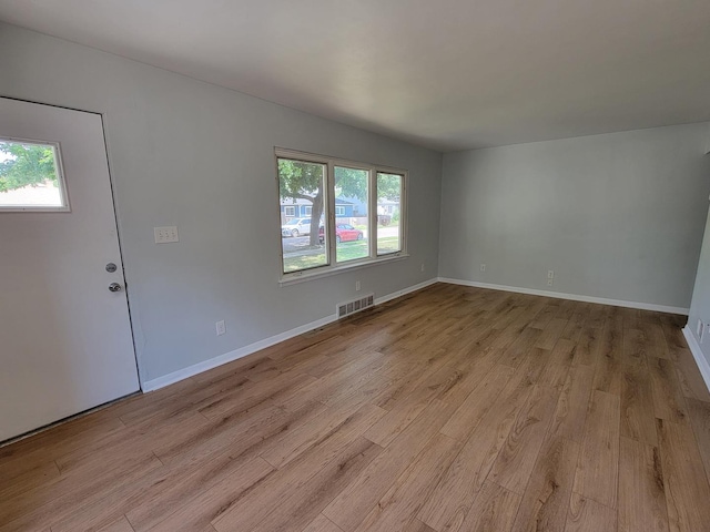 2928 Ridgeway Ave, Rockford, IL 61101 - unfurnished living room with healthy amount of natural light and light wood-style floors