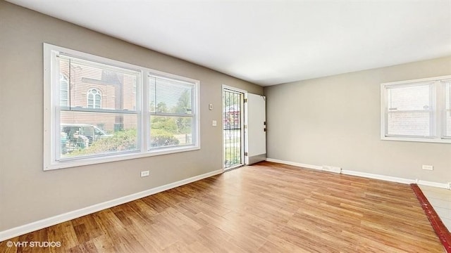 309 W 109th Pl, Chicago, IL 60628 - spare room featuring light wood-type flooring and baseboards