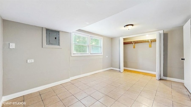 309 W 109th Pl, Chicago, IL 60628 - unfurnished bedroom featuring electric panel, a closet, and light tile patterned floors
