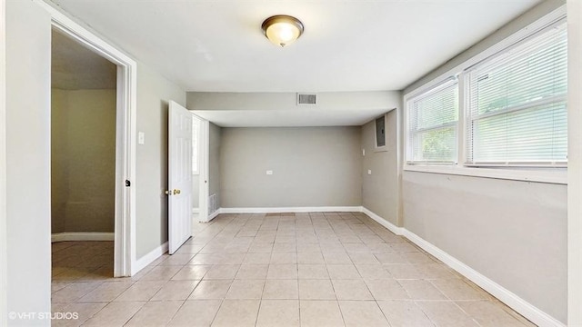 309 W 109th Pl, Chicago, IL 60628 - spare room featuring light tile patterned floors and baseboards