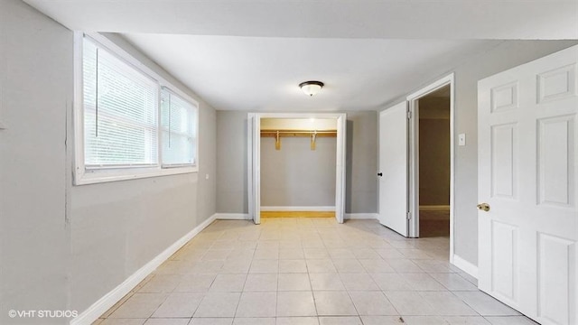 309 W 109th Pl, Chicago, IL 60628 - unfurnished bedroom with light tile patterned flooring and a closet