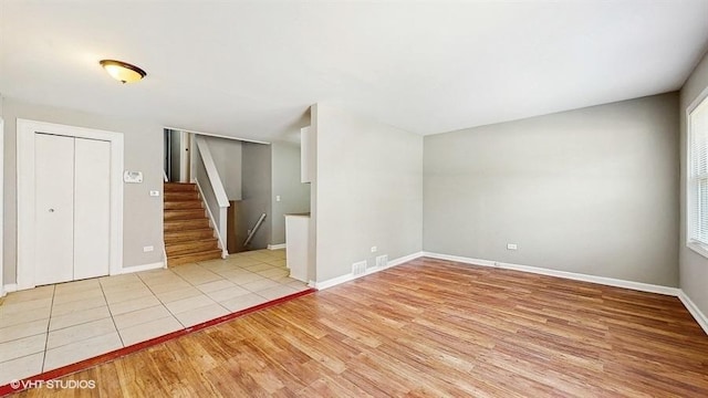 309 W 109th Pl, Chicago, IL 60628 - spare room featuring light wood-style flooring and stairway