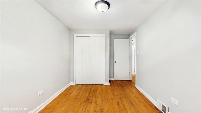 309 W 109th Pl, Chicago, IL 60628 - unfurnished bedroom with a closet and light wood-style flooring
