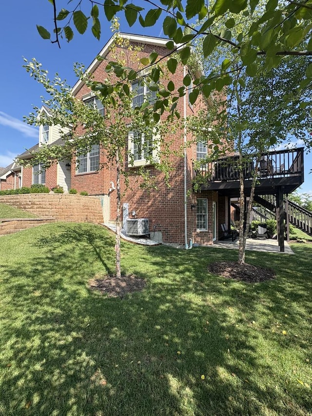 17 Harborside Way, Hawthorn Woods, IL 60047 - view of side of home with a wooden deck, brick siding, stairway, and a lawn