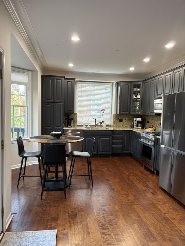 17 Harborside Way, Hawthorn Woods, IL 60047 - kitchen featuring stainless steel appliances, ornamental molding, tasteful backsplash, dark wood-type flooring, and glass insert cabinets