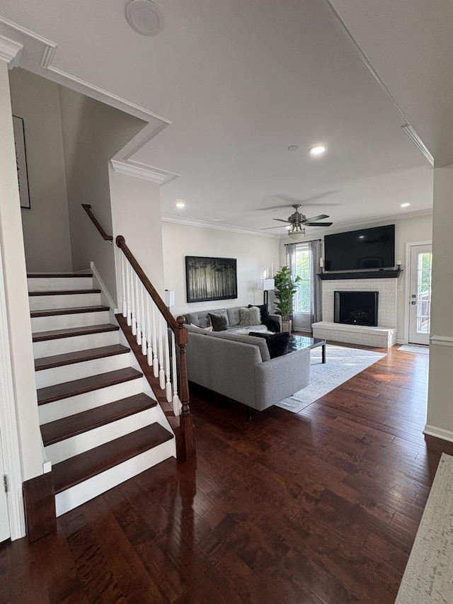 17 Harborside Way, Hawthorn Woods, IL 60047 - living room with a brick fireplace, a ceiling fan, wood finished floors, crown molding, and stairs