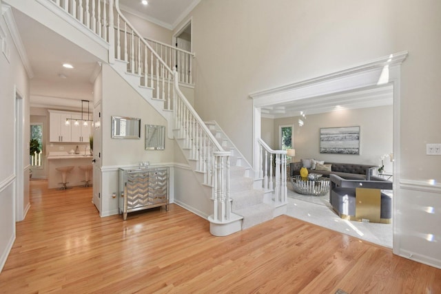 1123 Thackery Ln, Naperville, IL 60564 - stairway featuring wood finished floors, crown molding, plenty of natural light, and a towering ceiling