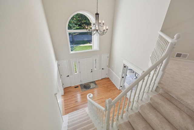 1123 Thackery Ln, Naperville, IL 60564 - foyer featuring a high ceiling, a chandelier, stairs, and wood finished floors