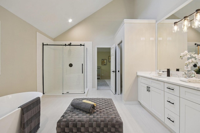 1123 Thackery Ln, Naperville, IL 60564 - full bathroom with lofted ceiling, double vanity, a freestanding tub, a shower stall, and recessed lighting