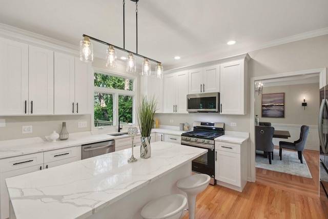 1123 Thackery Ln, Naperville, IL 60564 - kitchen featuring appliances with stainless steel finishes, white cabinets, ornamental molding, a kitchen bar, and light wood-style floors