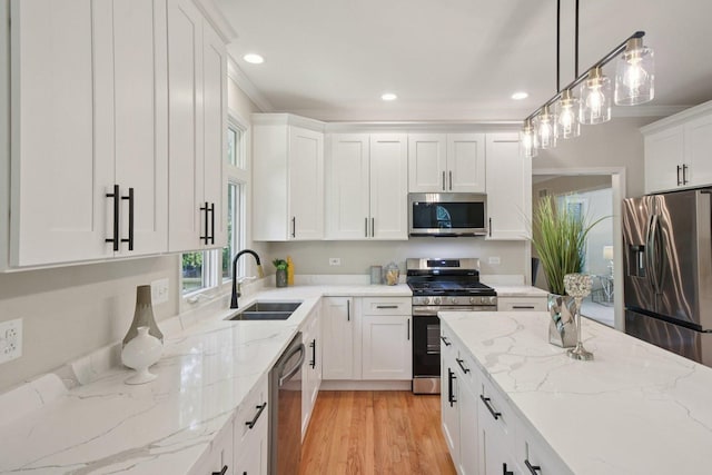 1123 Thackery Ln, Naperville, IL 60564 - kitchen with stainless steel appliances, recessed lighting, white cabinets, hanging light fixtures, and light wood-type flooring