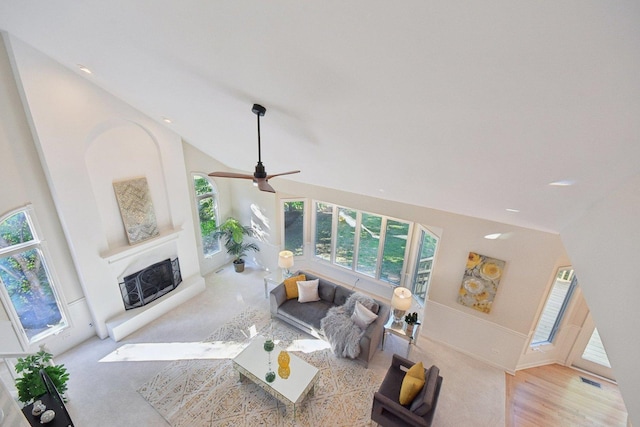 1123 Thackery Ln, Naperville, IL 60564 - living room featuring a fireplace with raised hearth, high vaulted ceiling, a ceiling fan, wood finished floors, and recessed lighting