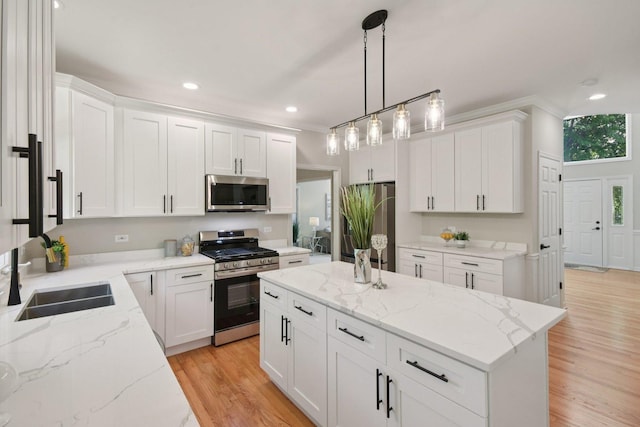 1123 Thackery Ln, Naperville, IL 60564 - kitchen with appliances with stainless steel finishes, a kitchen island, light wood-type flooring, white cabinets, and light stone counters