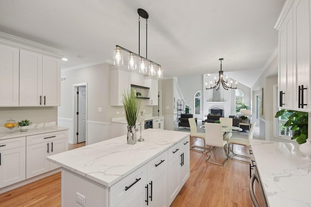 1123 Thackery Ln, Naperville, IL 60564 - kitchen featuring open floor plan, light wood finished floors, crown molding, white cabinetry, and a kitchen island