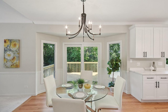 1123 Thackery Ln, Naperville, IL 60564 - dining space featuring light wood finished floors, a chandelier, and crown molding