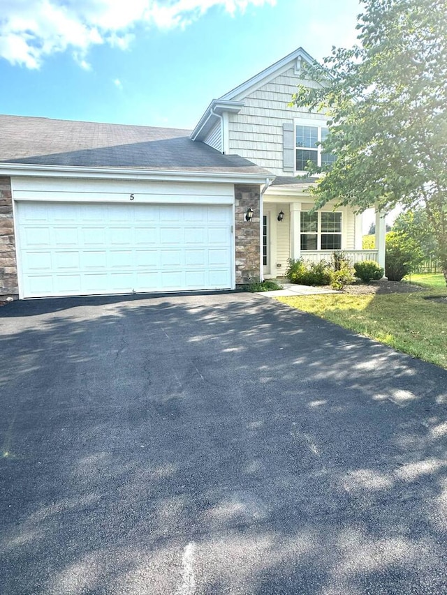 5 Boathouse Rd, Pingree Grove, IL 60140 - view of front of home featuring stone siding, driveway, and an attached garage