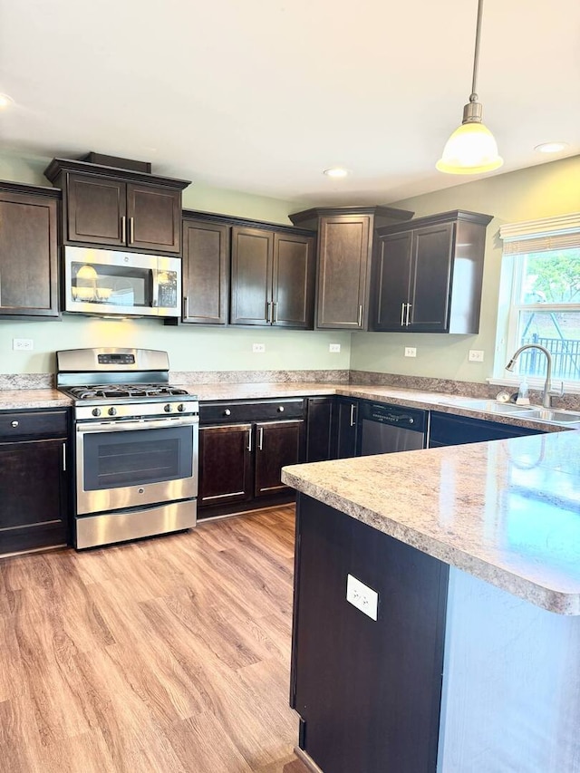 5 Boathouse Rd, Pingree Grove, IL 60140 - kitchen featuring stainless steel appliances, dark brown cabinets, pendant lighting, light wood-style flooring, and recessed lighting