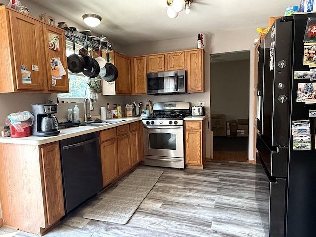 1907 Larkspur Dr, Plainfield, IL 60586 - kitchen featuring appliances with stainless steel finishes, light countertops, and brown cabinets