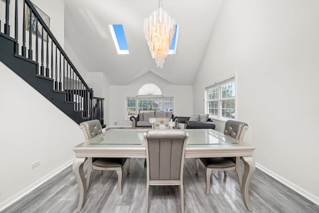 3032 Sandy Ridge Dr, Steger, IL 60475 - dining room featuring wood finished floors, stairway, a chandelier, and high vaulted ceiling