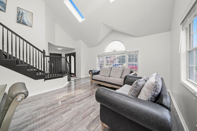 3032 Sandy Ridge Dr, Steger, IL 60475 - living room featuring stairway, wood finished floors, a skylight, and high vaulted ceiling