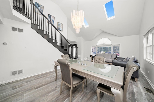 3032 Sandy Ridge Dr, Steger, IL 60475 - dining space with wood finished floors, a chandelier, stairway, high vaulted ceiling, and healthy amount of natural light