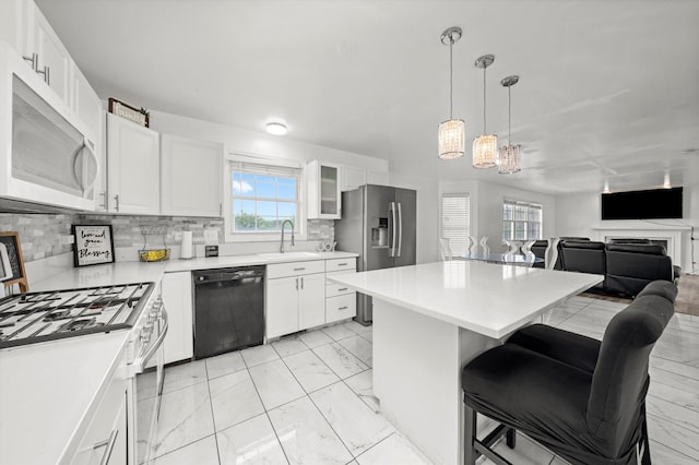 3032 Sandy Ridge Dr, Steger, IL 60475 - kitchen featuring dishwasher, white gas stove, stainless steel refrigerator with ice dispenser, light marble finish flooring, and a kitchen bar