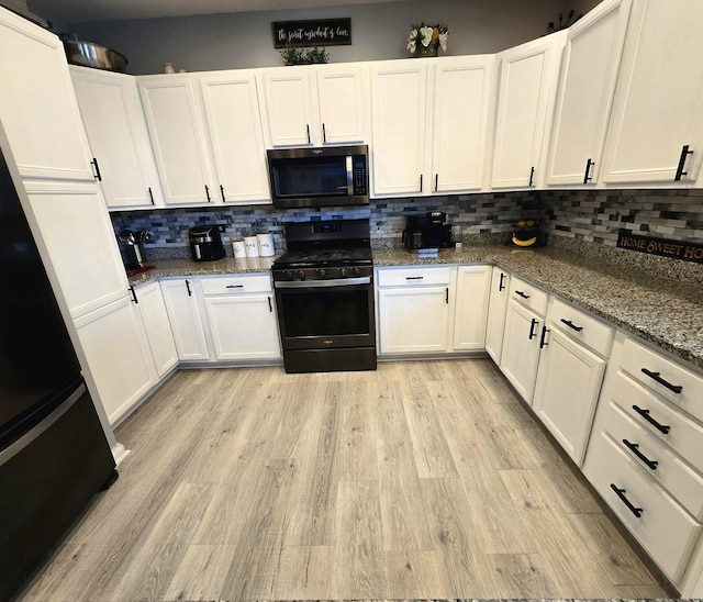 20517 Superior Ct, Crest Hill, IL 60403 - kitchen with gas stove, white cabinets, decorative backsplash, and light wood-style flooring