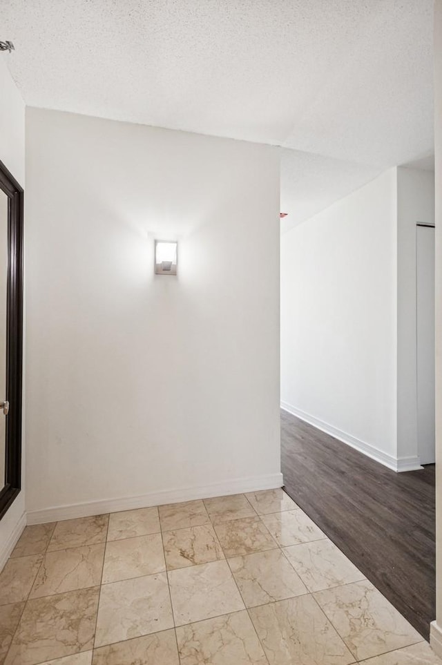 512 N Mcclurg Ct Unit 4302, Chicago, IL 60611 - spare room featuring marble look tiles and a textured ceiling