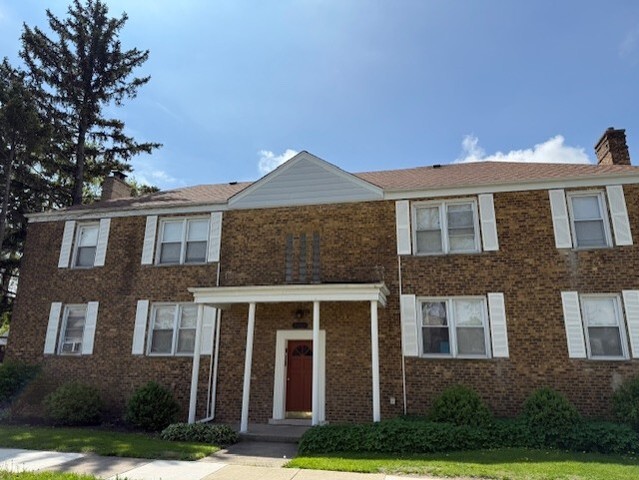 3608 Jackson St Unit 2E, Bellwood, IL 60104 - view of front facade with a chimney and brick siding