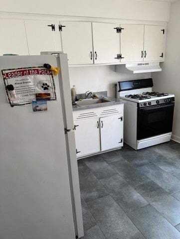 3608 Jackson St Unit 2E, Bellwood, IL 60104 - kitchen with white appliances, under cabinet range hood, white cabinets, and light countertops