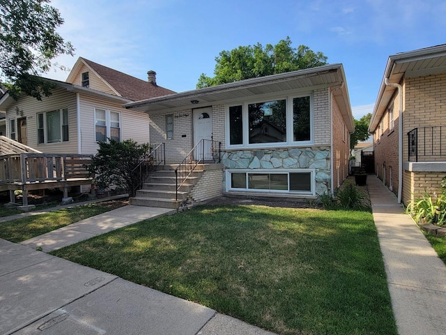 6308 W Cornelia Ave, Chicago, IL 60634 - view of front facade featuring a front yard and brick siding