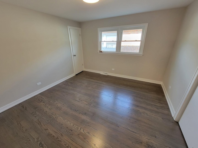 6308 W Cornelia Ave, Chicago, IL 60634 - empty room with dark wood-style flooring and baseboards