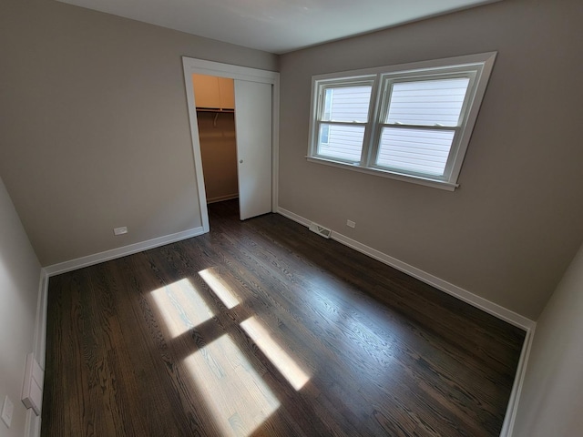 6308 W Cornelia Ave, Chicago, IL 60634 - unfurnished bedroom featuring dark wood-style flooring and a closet
