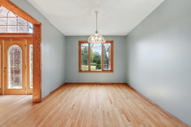 3664 E 2619th Rd, Sheridan, IL 60551 - unfurnished room featuring a chandelier and wood finished floors