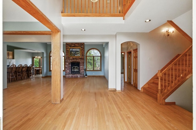 3664 E 2619th Rd, Sheridan, IL 60551 - foyer featuring light wood finished floors, a fireplace, arched walkways, stairs, and recessed lighting