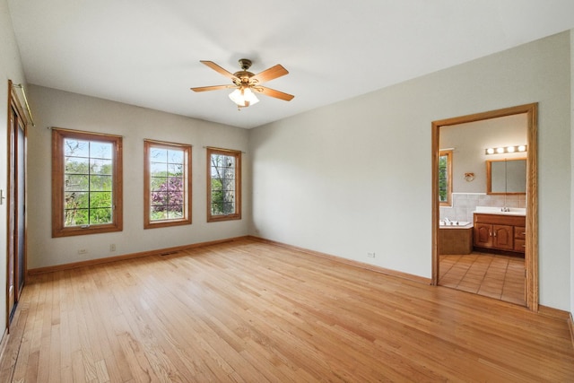 3664 E 2619th Rd, Sheridan, IL 60551 - unfurnished room featuring healthy amount of natural light, light wood-style floors, and a ceiling fan