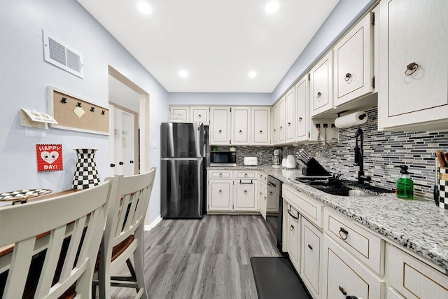 10048 S Pulaski Rd Unit 3F, Oak Lawn, IL 60453 - kitchen with appliances with stainless steel finishes, tasteful backsplash, light wood-style floors, light stone counters, and recessed lighting
