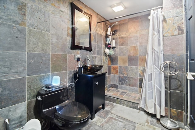 8040 W Balmoral Ave, Norwood Park Township, IL 60631 - bathroom featuring a tile shower, stone finish floors, vanity, and tile walls