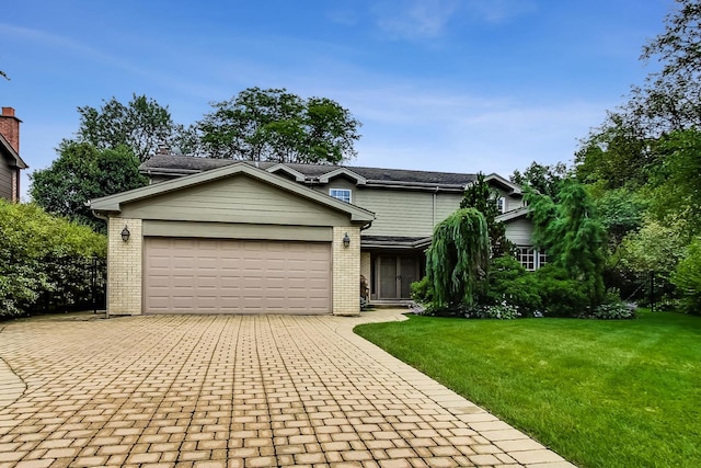1194 Oxford Ct, Highland Park, IL 60035 - view of front of property with brick siding, decorative driveway, an attached garage, and a front lawn
