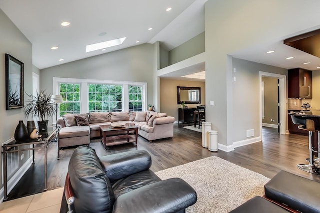 1194 Oxford Ct, Highland Park, IL 60035 - living area featuring a skylight, recessed lighting, wood finished floors, and high vaulted ceiling