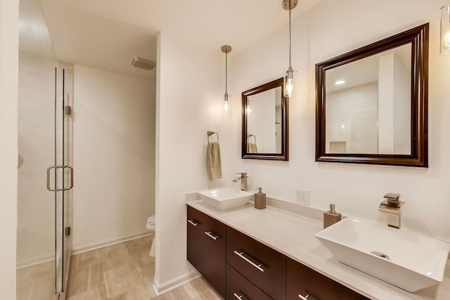 1194 Oxford Ct, Highland Park, IL 60035 - bathroom featuring double vanity, a shower stall, and wood finished floors