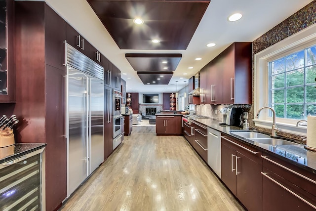 1194 Oxford Ct, Highland Park, IL 60035 - kitchen with beverage cooler, stainless steel appliances, light wood-style flooring, wall chimney exhaust hood, and modern cabinets