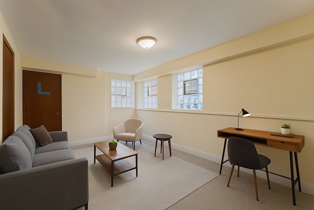 carpeted living room with baseboards