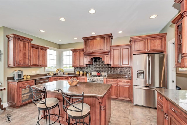 24155 S Blackhawk Ln, Manhattan, IL 60442 - kitchen featuring appliances with stainless steel finishes, a kitchen breakfast bar, light tile patterned flooring, tasteful backsplash, and recessed lighting