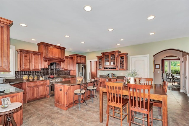 24155 S Blackhawk Ln, Manhattan, IL 60442 - kitchen with appliances with stainless steel finishes, arched walkways, dark countertops, recessed lighting, and backsplash