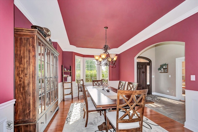 24155 S Blackhawk Ln, Manhattan, IL 60442 - dining area with arched walkways, wood finished floors, a chandelier, crown molding, and a raised ceiling