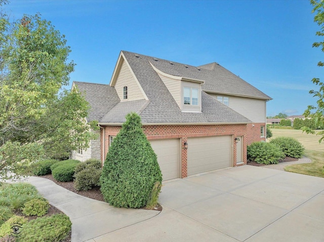 24155 S Blackhawk Ln, Manhattan, IL 60442 - view of property exterior with brick siding, roof with shingles, concrete driveway, and a garage