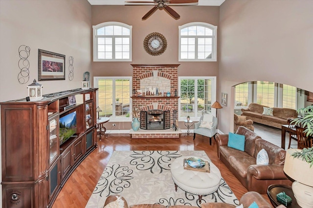24155 S Blackhawk Ln, Manhattan, IL 60442 - living area with ceiling fan, a high ceiling, light wood-style floors, plenty of natural light, and a fireplace