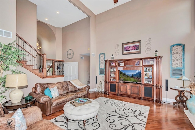 24155 S Blackhawk Ln, Manhattan, IL 60442 - living room featuring a towering ceiling, wood finished floors, stairs, and arched walkways