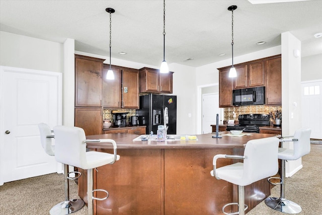 412 Doisy Ln, Champaign, IL 61822 - kitchen featuring black appliances, carpet, backsplash, a breakfast bar, and hanging light fixtures
